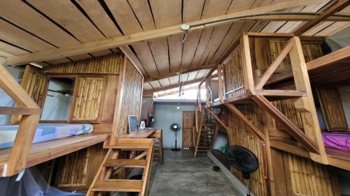 a room with two bunk beds and a desk at Roots Family in Puerto Viejo