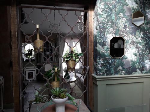 a hallway with potted plants on a wall at Ballybur Lodge Mews 1 in Kilkenny
