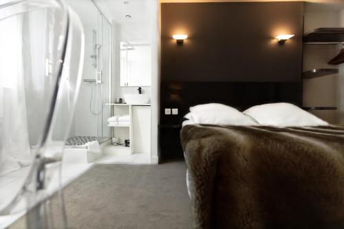 a bedroom with a bed with a black wall at Le Saint Louis in Amiens