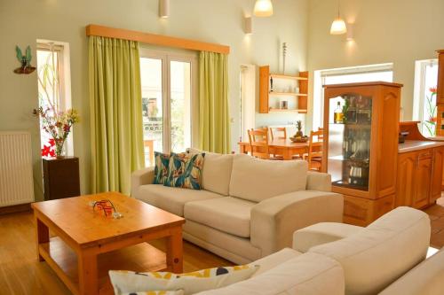 uma sala de estar com um sofá e uma mesa em Artemis House em Agios Georgios Pagon