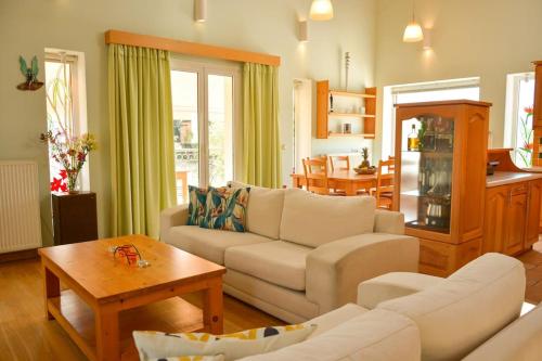 a living room with a couch and a table at Artemis House in Agios Georgios Pagon