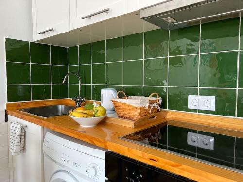 a kitchen counter with a sink and a bowl of fruit at Apartamento El Islote direct at Paradise Beach in El Cotillo