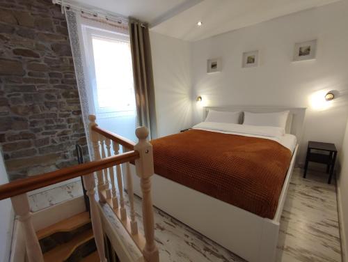 a bedroom with a bed and a staircase with a window at Lighthouse.Izola in Izola