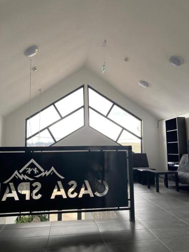 a room with a sign in the middle of a room at Pensiunea CASA SPANDO in Mărişel