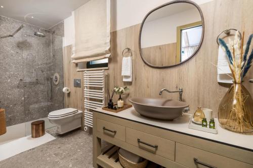 a bathroom with a sink and a toilet and a mirror at Villa Leucolea with pool in Cres