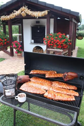 a grill with a bunch of food on it at Hotel & Restaurant Bergfried in Saalfeld