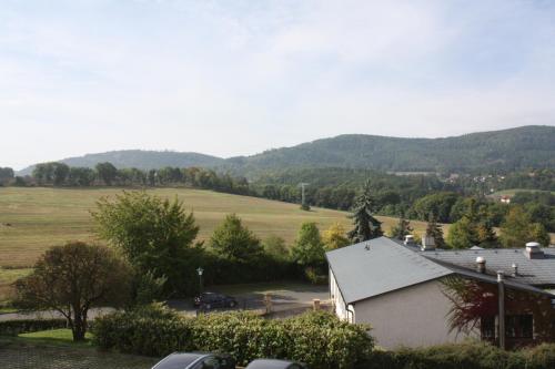 an aerial view of a farm with mountains in the background at Hotel & Restaurant Bergfried in Saalfeld
