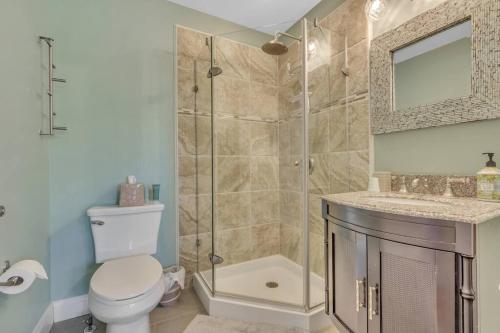 a bathroom with a shower and a toilet and a sink at Saltwater Inn in Belmar