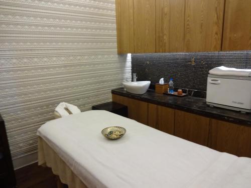 a hospital room with a bed and a sink at The Claridges Nabha Residence in Mussoorie
