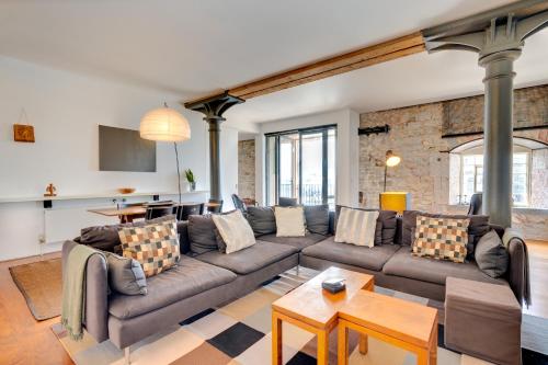a living room with a couch and a table at Royal William Yard Apartments in Plymouth