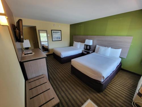 a hotel room with two beds and a television at Quality Inn Flamingo in Atlantic City