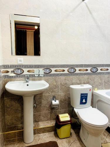 a bathroom with a toilet and a sink and a mirror at Зона отдых APACHI в горах ЧИМГАН in Chimgan
