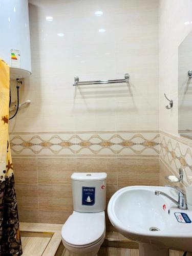 a bathroom with a toilet and a sink at Зона отдых APACHI в горах ЧИМГАН in Chimgan