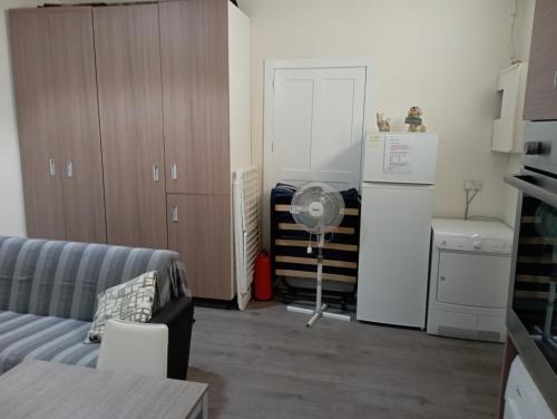 a living room with a couch and a refrigerator at Private village apartment in Kirkop