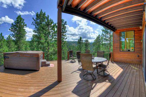a wooden deck with a table and a hot tub at Eagle Crest Nest in Spearfish