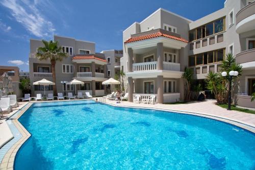 a large swimming pool in front of a building at Stavroula Hotel Palace in Kissamos