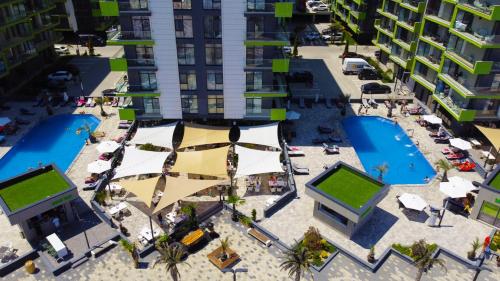 an aerial view of a city with pools and buildings at CRYSTAL ApartHotel & Spa Mamaia Nord in Mamaia Sat/Năvodari