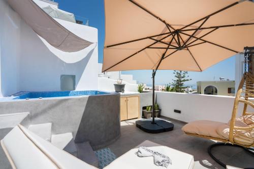 a patio with a chair and an umbrella on a roof at The Muses of Santorini Private Jacuzzi Suites in Vóthon