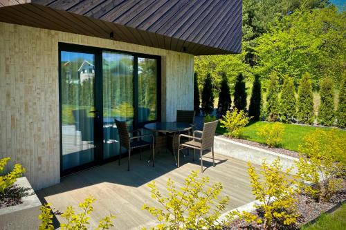 a patio with a table and chairs on it at SIRENA in Palanga