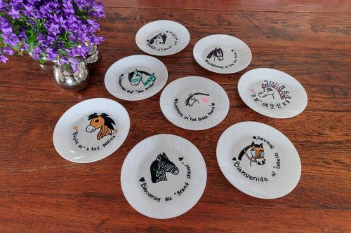four white plates with animals on them on a table at Het Grote Paard in Havelte