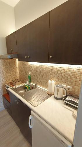 a kitchen with a sink and a counter top at Sea & Sun cozy studio in Kremasti