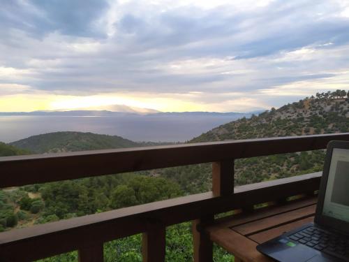 a laptop sitting on a balcony with a view of the ocean at Eden View in Sotír