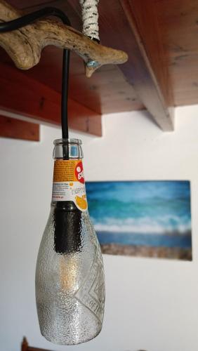 a glass bottle hanging from a ceiling at Mikros Paradisos Pelion in Áyios Vlásios