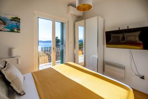 a bedroom with a bed with a view of the ocean at Ponte Apartment in Orasac