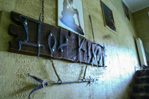 a wall with weapons hanging on a wall at Don Kihot Hotel in Novovolynsʼk