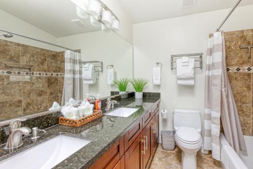 a bathroom with a tub and a sink and a toilet at Saguaro Siesta in Phoenix