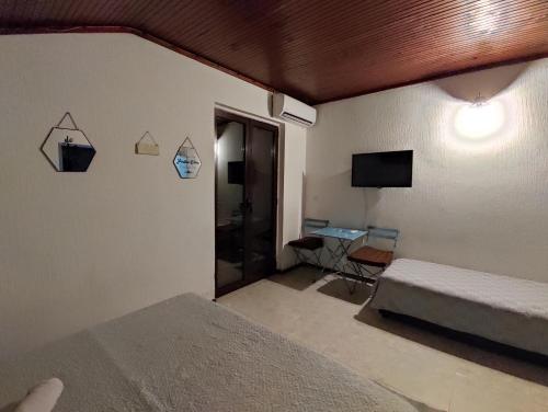 a bedroom with a bed and a tv on the wall at Vojinovic Apartments in Budva
