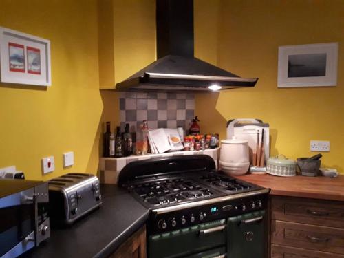 a kitchen with a stove top oven in a kitchen at Room with a view in Killarney