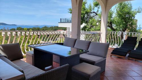a patio with a table and chairs on a porch at Apartmani Stipe in Drage