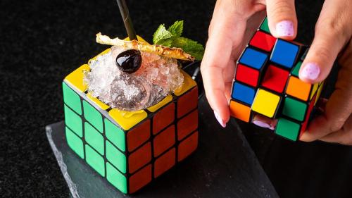 a person holding a piece of food in a lego box at InterContinental Budapest by IHG in Budapest