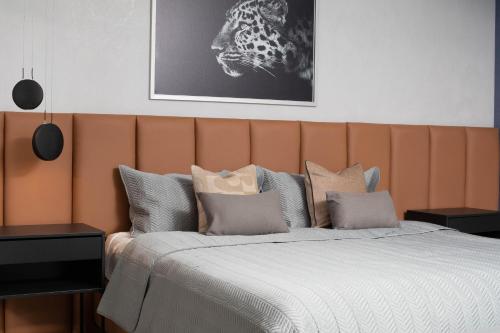 een slaapkamer met een groot bed met een oranje hoofdeinde bij New Modern Lux City Condo With Pool And Gym Ocean View Santo Domingo in Ciudad Nueva