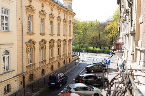 a group of cars parked in front of a building at Salve station in Krakow