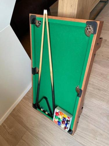 a green pool table sitting on top of a floor at LOFT neuf avec bain jacuzzi et terrasse in Colmar