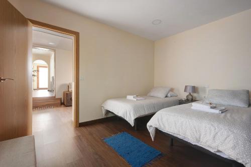 una camera da letto con due letti e uno specchio di Casa Margarita a La Guancha