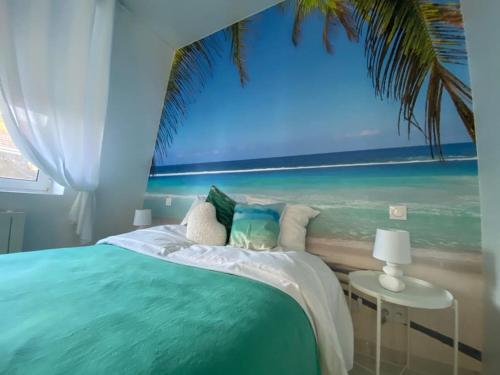 a bedroom with a bed with a painting of the beach at Esprit MALDIVES ...... SPA LOVE au coeur de Mulhouse in Mulhouse