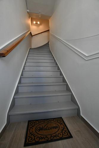 a stairwell with a rug on the floor next to it at DownTown Loft in Aígio