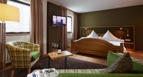 a hotel room with a bed and a tv at Eurener Hof in Trier