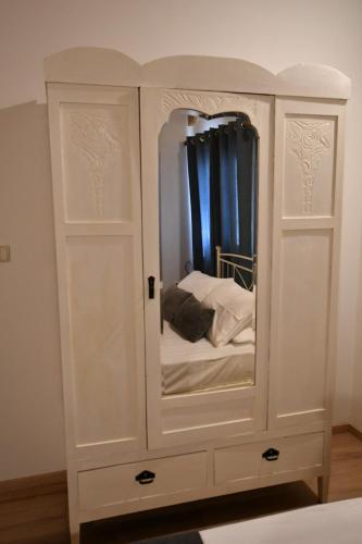 a white cabinet with a bed in it at DownTown Loft in Aígio