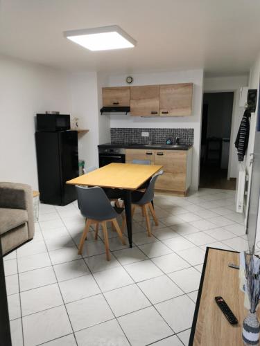 a kitchen and dining room with a table and chairs at Au Petit Bonheur Malouin in Malo-les-Bains