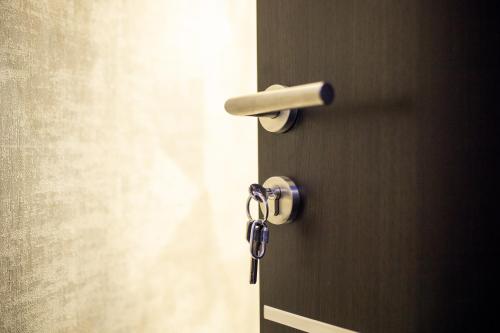 a door with a lock and a key on it at Foča Apartmani "Story Lux" in Foča