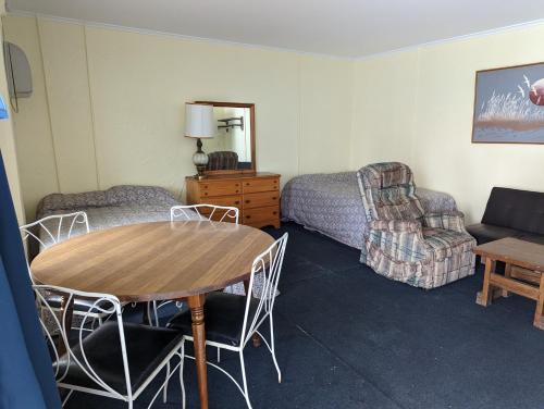 a living room with a table and chairs and a couch at 7 Beachside inn in Hampton