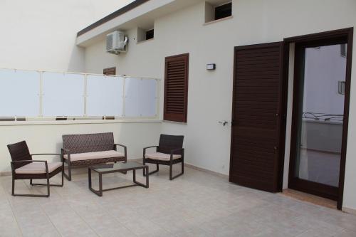 a group of chairs and a table in a room at B&B San Vito in Tricase