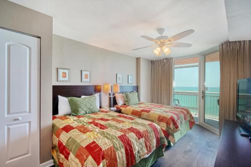 a bedroom with a bed and a balcony with the ocean at Prince Resort 1708 in Myrtle Beach