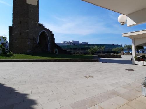 a patio with a brick tower in the background at Apartment Kristjan in Portorož