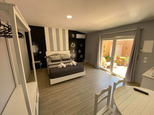 a bedroom with a bed and a view of a patio at Cantinho do Sol (Estúdio Prata) in Lourinhã