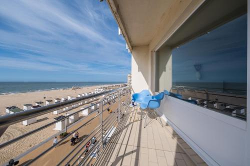 a view of the beach from the balcony of a building at Ostend Luxury Seasight Apartment in Ostend